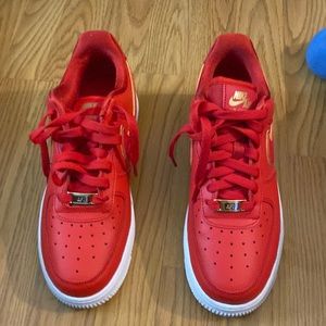 Red women’s Air Force 1 “07 red with gold in nike swoosh symbol so nice